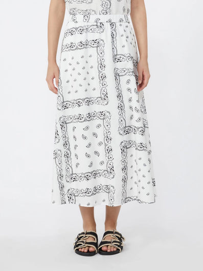 Person wearing a white dress with black pattern on a white background