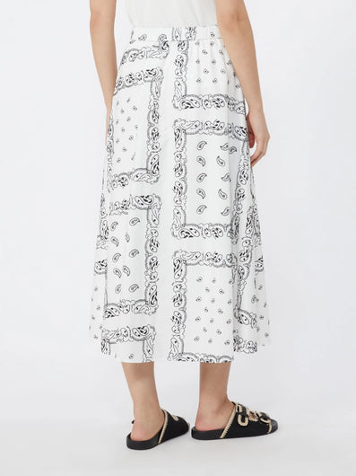 Person wearing a white dress with black pattern on a white background